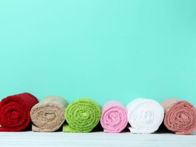 Colorful rolled up towels on green background Colorful rolled up towels on green background